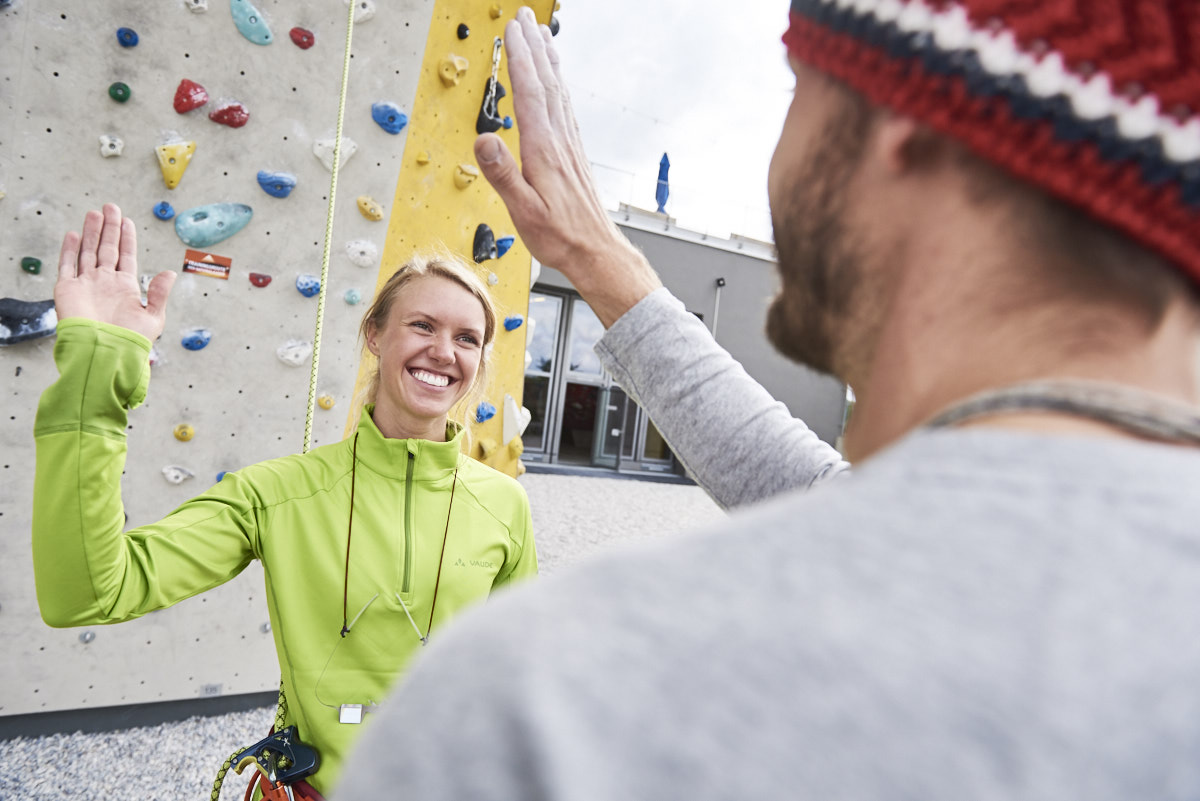 2 Kletterer klatschen sich im Outdoorbereich ab